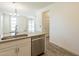 Modern kitchen with stainless steel dishwasher and sink, complemented by stylish cabinets and wood-look floors at 300 N Gila Springs Blvd # 144, Chandler, AZ 85226