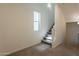 Carpeted stairway with natural light filtering through a window, leading to the upper level of the home at 300 N Gila Springs Blvd # 144, Chandler, AZ 85226