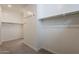 Spacious walk-in closet features carpeted floor and white walls with a chrome rod and hooks at 300 N Gila Springs Blvd # 144, Chandler, AZ 85226