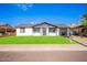 Charming single-story home featuring a well-manicured lawn and a classic design at 5948 W Holly St, Phoenix, AZ 85035