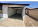 Attached one-car garage with painted siding and concrete driveway, offering convenient parking and storage at 5948 W Holly St, Phoenix, AZ 85035