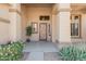 Inviting front entrance with decorative door, desert landscaping and covered porch at 6971 W El Cortez Pl, Peoria, AZ 85383