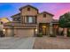 Inviting two-story home with a three car garage and desert landscaping at 6971 W El Cortez Pl, Peoria, AZ 85383