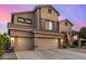 Inviting two-story home with a three car garage and desert landscaping at 6971 W El Cortez Pl, Peoria, AZ 85383