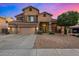 Inviting two-story home with a three car garage and desert landscaping at 6971 W El Cortez Pl, Peoria, AZ 85383