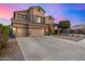 Inviting two-story home with a three car garage and desert landscaping at 6971 W El Cortez Pl, Peoria, AZ 85383