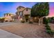 Inviting two-story home with a three car garage and desert landscaping at 6971 W El Cortez Pl, Peoria, AZ 85383
