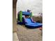 View of an inflatable water slide in a backyard with a kid and adult in the shot at 714 W Wind Cave Dr, San Tan Valley, AZ 85140