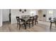 Bright dining room with a long wooden table, neutral walls and light wood flooring at 10543 E Sahuaro Dr, Scottsdale, AZ 85259