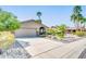 Single-story home with desert landscaping, two-car garage, and charming curb appeal at 10543 E Sahuaro Dr, Scottsdale, AZ 85259