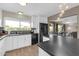 Open kitchen with black appliances, sleek countertops, and view into the adjacent dining area at 10543 E Sahuaro Dr, Scottsdale, AZ 85259