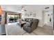 Spacious living room with comfortable seating, a ceiling fan, and sliding glass doors to the patio at 10543 E Sahuaro Dr, Scottsdale, AZ 85259