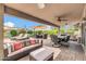 Outdoor living space featuring a covered patio, multiple seating and lounge areas, and lush landscaping at 10543 E Sahuaro Dr, Scottsdale, AZ 85259