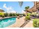 Backyard with pool, lush tropical landscaping, and outdoor seating areas under large umbrellas at 10543 E Sahuaro Dr, Scottsdale, AZ 85259