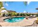 Backyard with pool, lush tropical landscaping, and outdoor seating areas under large umbrellas at 10543 E Sahuaro Dr, Scottsdale, AZ 85259