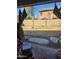 View from covered patio of gravel and grass backyard with privacy wall at 11590 W Cocopah St, Avondale, AZ 85323