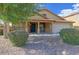 Charming single-story home featuring a covered porch, a well-manicured lawn, and an attached two-car garage at 11590 W Cocopah St, Avondale, AZ 85323