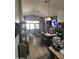 Tile flooring and living area with a dining table and views of the kitchen at 11590 W Cocopah St, Avondale, AZ 85323