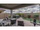 Relaxing backyard with a covered patio, cozy seating, and a rejuvenating hot tub for outdoor enjoyment at 12158 S 184Th Ave, Goodyear, AZ 85338