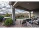 Inviting backyard featuring a hot tub, patio area, and artificial turf creating a low-maintenance oasis at 12158 S 184Th Ave, Goodyear, AZ 85338