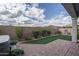 Well-maintained backyard with artificial turf, and desert landscaping, ideal for low-maintenance outdoor living at 12158 S 184Th Ave, Goodyear, AZ 85338