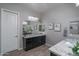 Bathroom featuring dual vanities, granite countertops, and modern fixtures at 12158 S 184Th Ave, Goodyear, AZ 85338