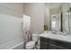 Bright bathroom features a shower-tub combination and vanity with neutral decor and a large mirror at 12158 S 184Th Ave, Goodyear, AZ 85338