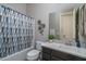 Clean bathroom featuring modern vanity, tiled backsplash, and shower-tub combination with a neutral color scheme at 12158 S 184Th Ave, Goodyear, AZ 85338