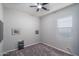 This simple bedroom features a ceiling fan and carpeting, ready for personalization and comfortable living at 12158 S 184Th Ave, Goodyear, AZ 85338