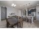 Open dining area with a large table and chairs, seamlessly connected to the kitchen island at 12158 S 184Th Ave, Goodyear, AZ 85338