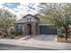 Charming single-story home featuring a stone archway, tile roof, desert landscaping, and a two-car garage at 12158 S 184Th Ave, Goodyear, AZ 85338