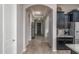 Inviting hallway boasts arched entryways, wood-look flooring, and seamless transition to the adjacent kitchen at 12158 S 184Th Ave, Goodyear, AZ 85338