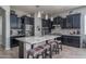 Modern kitchen with black cabinets, granite countertops, a large island, and stylish pendant lighting at 12158 S 184Th Ave, Goodyear, AZ 85338