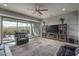 Comfortable living room with a ceiling fan, sliding glass doors, and stylish furniture at 12158 S 184Th Ave, Goodyear, AZ 85338