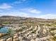 This elevated view of the community showcases the surrounding mountains and desert landscape and nearby lakes at 1248 E Briarwood Ter, Phoenix, AZ 85048