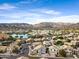 Community aerial view showcasing a lake, homes, and rolling mountain views in the distance at 1248 E Briarwood Ter, Phoenix, AZ 85048