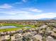This aerial view features a golf course and lake amid a residential community with distant mountain views at 1248 E Briarwood Ter, Phoenix, AZ 85048
