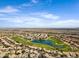 Overhead community view showcasing a lake, surrounding residences, and distant landscape at 1248 E Briarwood Ter, Phoenix, AZ 85048
