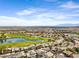 A fantastic aerial view featuring a golf course, a lake, and surrounding homes against a scenic desert backdrop at 1248 E Briarwood Ter, Phoenix, AZ 85048