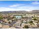 This aerial view showcases the community with lake views and mountain views beyond the homes and mature landscaping at 1248 E Briarwood Ter, Phoenix, AZ 85048