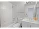 Clean bathroom featuring tub, shower, toilet, and vanity, all finished with white tile at 1248 E Briarwood Ter, Phoenix, AZ 85048