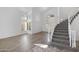 Welcoming foyer featuring a curved staircase, high ceilings, light-colored wood flooring, and bright natural light at 1248 E Briarwood Ter, Phoenix, AZ 85048