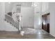 Open foyer with wood-look flooring, a curved staircase, and high ceilings, creating an airy atmosphere at 1248 E Briarwood Ter, Phoenix, AZ 85048