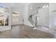 Open living room showcasing staircase, wood flooring and high ceilings with bright, natural light at 1248 E Briarwood Ter, Phoenix, AZ 85048