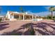 Expansive backyard showcasing a covered patio, private pool, lush greenery, and serene outdoor living space at 12835 W Chapala Ct, Sun City West, AZ 85375