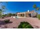 Inviting backyard featuring a sparkling pool, covered patio, and meticulously manicured landscaping at 12835 W Chapala Ct, Sun City West, AZ 85375