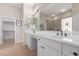 Bathroom featuring dual vanities, spacious counters, and a glass-enclosed shower with decorative tiling at 12835 W Chapala Ct, Sun City West, AZ 85375