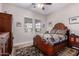 Comfortable bedroom with a patterned rug, a ceiling fan, and bright natural light streaming through the blinds at 12835 W Chapala Ct, Sun City West, AZ 85375