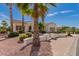 Beautiful desert home featuring lush landscaping and palm trees in a serene neighborhood at 12835 W Chapala Ct, Sun City West, AZ 85375