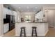 Open kitchen with breakfast bar featuring granite counters, stainless appliances and modern pendant lighting at 12835 W Chapala Ct, Sun City West, AZ 85375